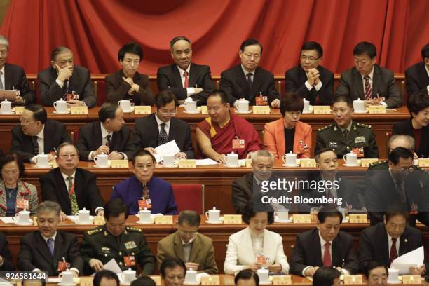 Gyaltsen Norbu, China's official Tibetan spiritual leader, the Panchen Lama, third row center, and other delegates sit ahead of the opening of the...