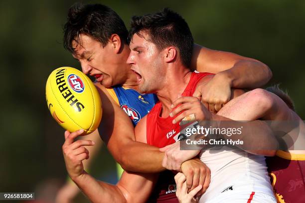 Nic Newman of the Swans is tackled by Hugh McCluggage of the Lions during the AFL JLT Community Series match between the Brisbane Lions and the...