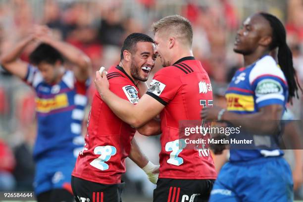 Bryn Hall of the Crusaders celebrates with team mate Jack Goodhue after scoring a try during the round two Super Rugby match between the Crusaders...