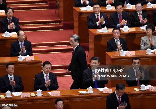 Yu Zhengsheng , Chairman of the National Committee of the Chinese People's Political Consultative Conference , walks past China's President Xi...