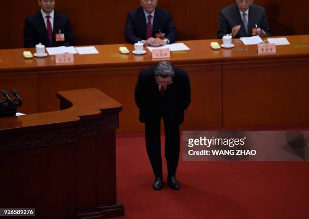 Yu Zhengsheng, Chairman of the National Committee of the Chinese People's Political Consultative Conference , bows to delegates during the opening...