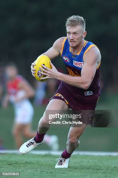 Nick Robertson of the Lions runs the ball during the AFL JLT Community Series match between the Brisbane Lions and the Sydney Swans at Moreton Bay...