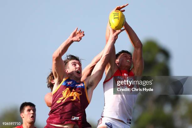Callum Sinclair of th Swans takes a mark over Daniel McStay of the Lions during the AFL JLT Community Series match between the Brisbane Lions and the...