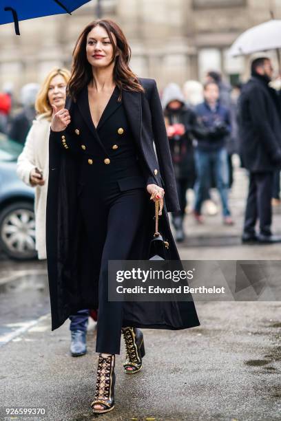 Olga Kurylenko is seen, outside Balmain, during Paris Fashion Week Womenswear Fall/Winter 2018/2019, on March 2, 2018 in Paris, France.