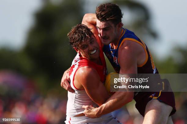 Dane Rampe of the Swans is tackled by Daniel McStay of the Lions during the AFL JLT Community Series match between the Brisbane Lions and the Sydney...