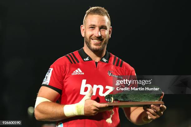 Luke Romano of the Crusaders poses with a greenstone mere after playing one hundred games during the round two Super Rugby match between the...