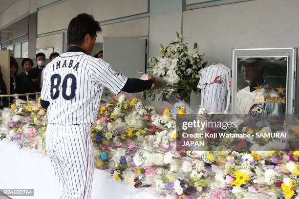 Japan head coach Atsunori Inaba offers a flower in commemoration for late Japan national team head coach Senichi Hoshino prior to during the game one...