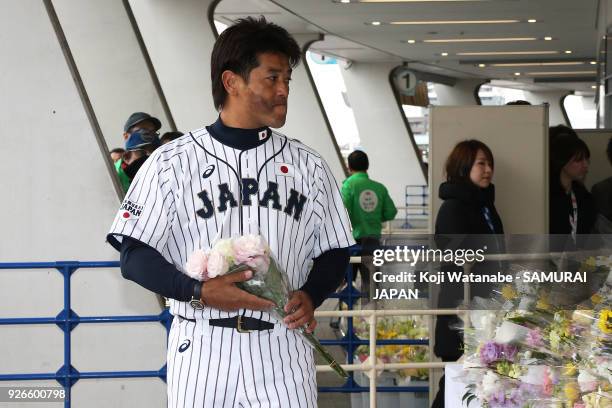 Japan head coach Atsunori Inaba offers a flower in commemoration for late Japan national team head coach Senichi Hoshino prior to during the game one...