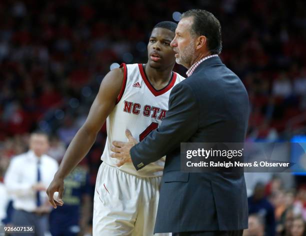 North Carolina State head coach Mark Gottfried talks with Dennis Smith Jr. During action against Georgia Southern at the PNC Center in Raleigh, N.C.,...