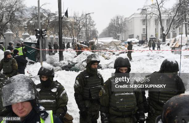 Policemen destroy tents camp of supporters of Mikheil Saakashvili set in front of the Ukrainian parliament in Kiev, after they took it by force early...