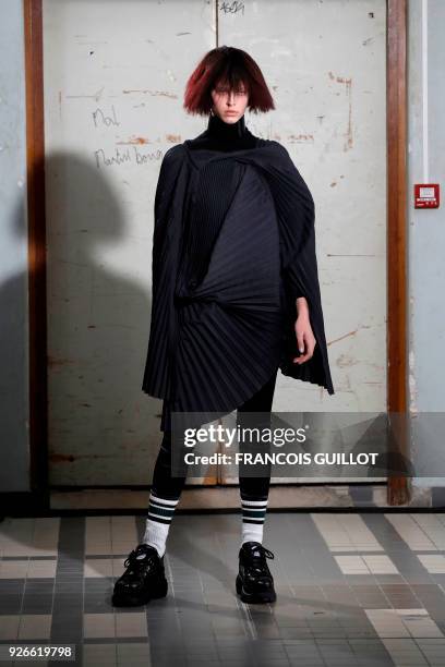 Model presents a creation by Junya Watanabe during the 2018/2019 fall/winter collection fashion show on March 3, 2018 in Paris.