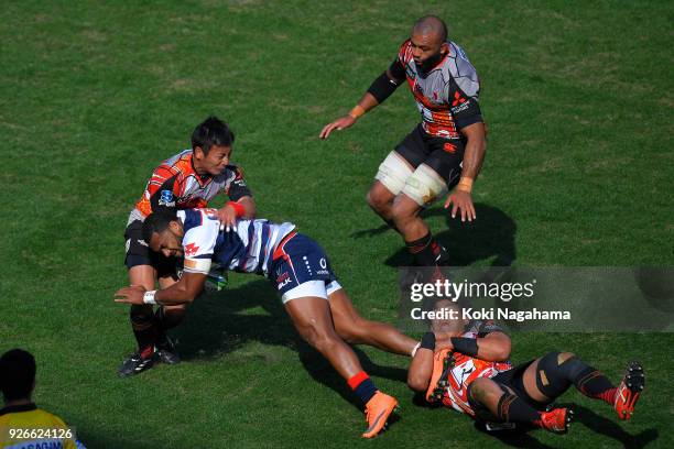 Yutaka Nagere of Sunwolves and Yoshitaka Tokunaga of Sunwolves make a tackle on Sefa Naivalu during the Super Rugby round 3 match between Sunwolves...