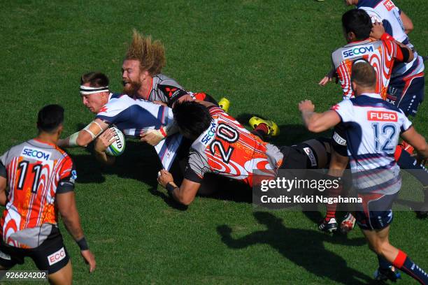 Yoshitaka Tokunaga of Sunwolves and Willem Britz of Sunwolves make a tackle on Jack Maddocks of Rebels during the Super Rugby round 3 match between...