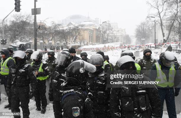 Policemen guard the tents camp of supporters of Mikheil Saakashvili set in front of the Ukrainian parliament in Kiev, after they took it by force...