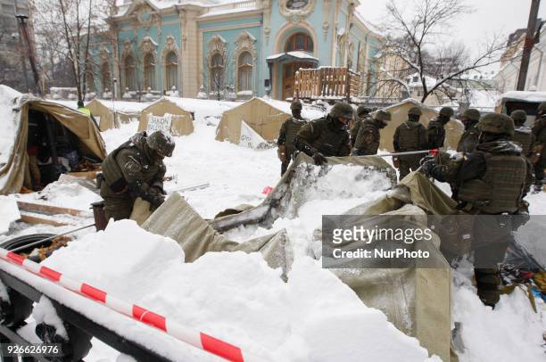 Ukrainian National Guard soldiers dismantle a tent camp of supporters of former Georgian President Mikheil Saakashvili, near Ukrainian Parliament, in...