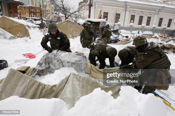 Ukrainian National Guard soldiers dismantle a tent camp of supporters of former Georgian President Mikheil Saakashvili, near Ukrainian Parliament, in...