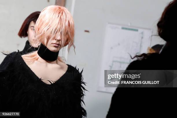 Models present creations by Junya Watanabe during the 2018/2019 fall/winter collection fashion show on March 3, 2018 in Paris.