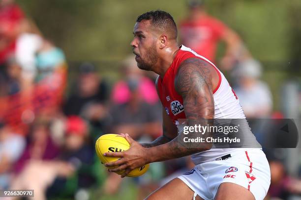 Lance Franklin of the Swans handballs during the AFL JLT Community Series match between the Brisbane Lions and the Sydney Swans at Moreton Bay...