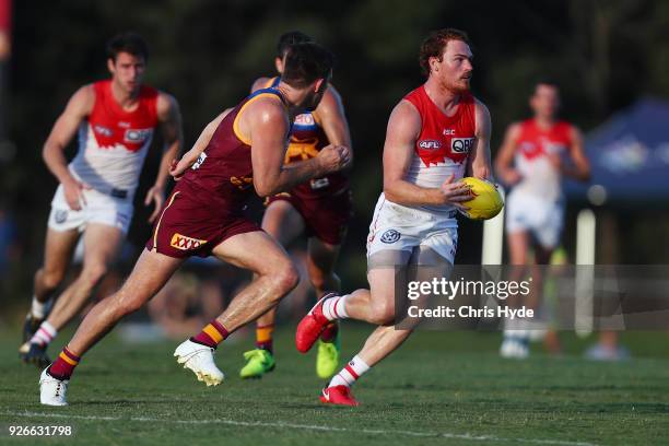 Gary Rohan of the Swans runs the ball during the AFL JLT Community Series match between the Brisbane Lions and the Sydney Swans at Moreton Bay...