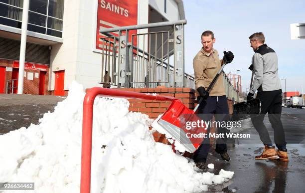 Southampton's Commercial Director David Thomas and Managing Director Toby Steele shovel snow ahead of the Premier League match between Southampton...