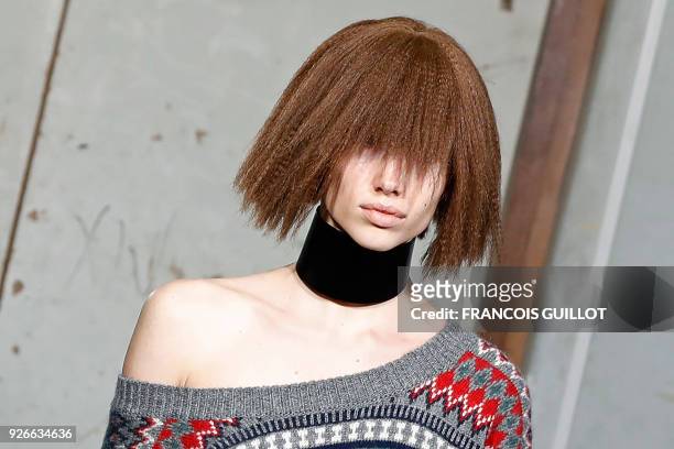 Model presents a creation by Junya Watanabe during the 2018/2019 fall/winter collection fashion show on March 3, 2018 in Paris.