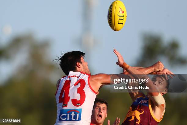 Lewis Melican of the Swans and Eric Hipwood of the Lions comepete for the ball during the AFL JLT Community Series match between the Brisbane Lions...