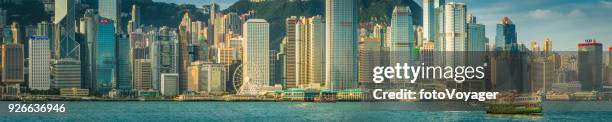 hong kong harbour ferry skyscraper skyline panorama golden sunrise china - hong kong harbour stock pictures, royalty-free photos & images