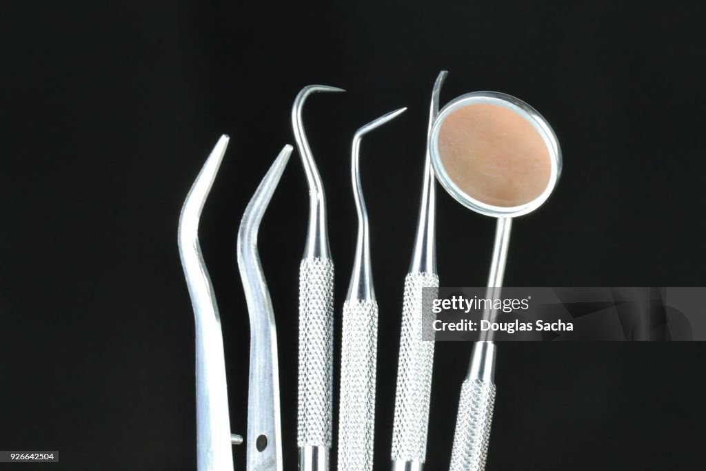 Dentist tools on a black background