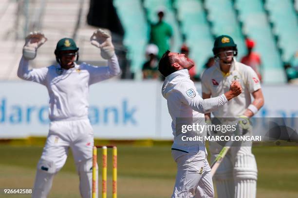 South African bowler Dean Elgar celebrates after taking the wicket of Australian batsman Steven Smith during the third day of the first Test cricket...