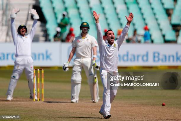 South African bowler Dean Elgar celebrates after taking the wicket of Australian batsman Steven Smith during the third day of the first Test cricket...