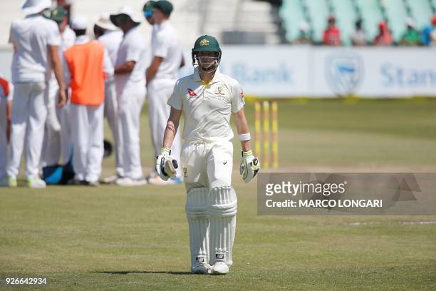 Australian batsman Steven Smith walks back to the pavilion after his dismissal by South African bowler Dean Elgar during the third day of the first...