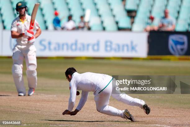 South African bowler Dean Elgar dives as he attempts to take a catch off his own bowling during the third day of the first Test cricket match between...