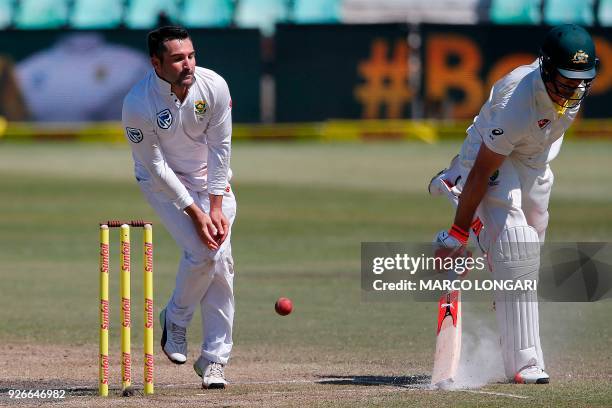 Australian batsman Mitchell Marsh safely makes his ground as South African fielder Dean Elgar fields the ball during the third day of the first Test...