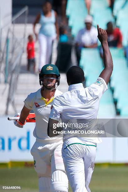 South African bowler Kagiso Rabada celebrates after taking the wicket of Australian batsman Mitchell Marsh during the third day of the first Test...