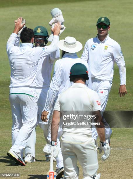 Quinton de Kock and Dean Elgar of the Proteas celebrate the wicket of Steven Smith of Australia during day 3 of the 1st Sunfoil Test match between...