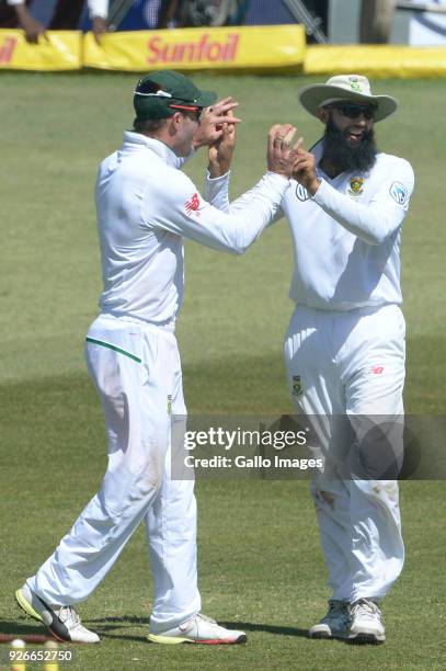 De Villiers and Hashim Amla of the Proteas celebrate the wicket of Mitchell Marsh of Australia during day 3 of the 1st Sunfoil Test match between...