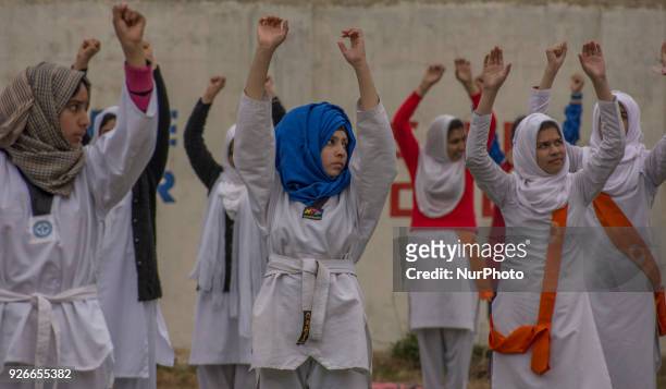 Kashmiri Muslim girls learn martial arts from a coach in the courtyard of a school on February 28, 2018 in Srinagar, the summer capital of Indian...