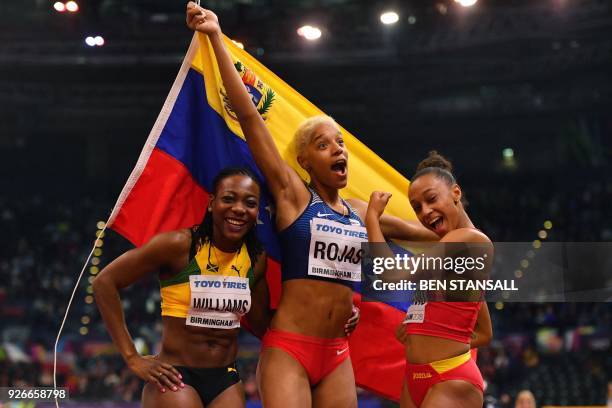 Second placed Jamaica's Kimberly Williams, winner Venezuela's Yulimar Rojas and third placed Spain's Ana Peleteiro pose after the women's triple jump...