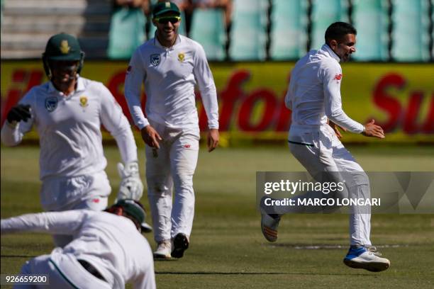 South African bowler Keshav Maharaj celebrates after taking the wicket of Australian batsman Tim Paine during the third day of the first Test cricket...