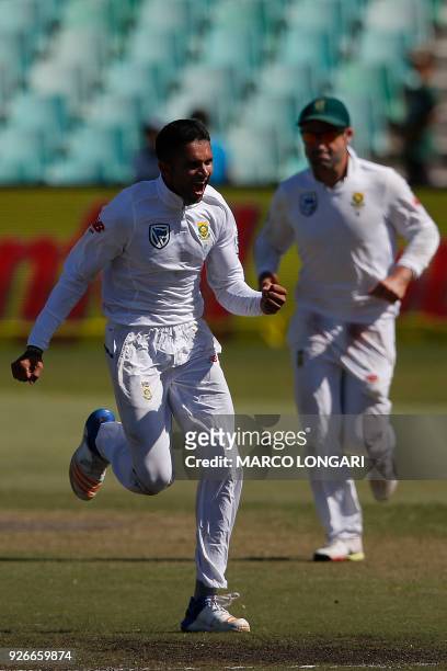 South African bowler Keshav Maharaj celebrates after taking the wicket of Australian batsman Tim Paine during the third day of the first Test cricket...