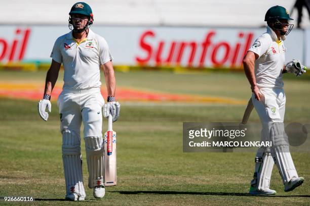 Australian batsman Tim Paine walks back to the pavilion after his dismissal by South African bowler Keshav Maharaj during the third day of the first...