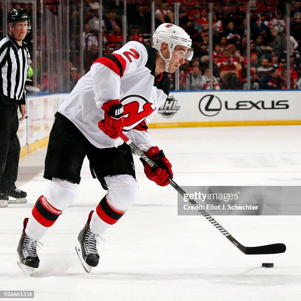John Moore of the New Jersey Devils skates with the puck against the Florida Panthers at the BB&T Center on March 1, 2018 in Sunrise, Florida.