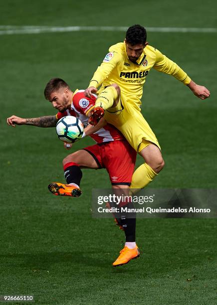 Alvaro Gonzalez of Villarreal competes for the ball with Cristian Portugues of Girona during the La Liga match between Villarreal and Girona at...