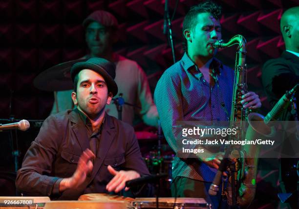 Vocalist Jeremy De Jesus plays congas as he performs with Joaquin Pozo' band at Joe's Pub nightclub, New York, New York, October 28, 2013. Visible...