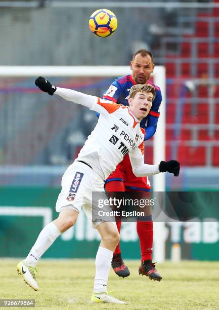 Sergei Ignashevich of PFC CSKA Moscow vies for the ball with Vladimir Ilyin of FC Ural Ekaterinburg during the Russian Premier League match between...