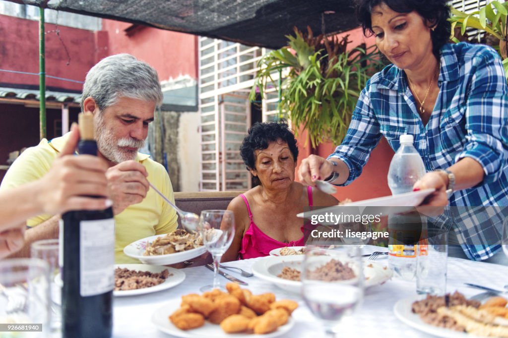 Multi-generation Cuban Family having dinner outdoors