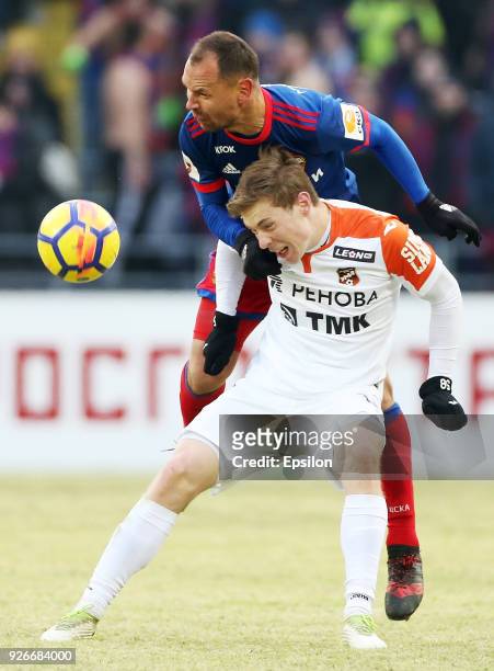 Sergei Ignashevich of PFC CSKA Moscow vies for the ball with Vladimir Ilyin of FC Ural Ekaterinburg during the Russian Premier League match between...