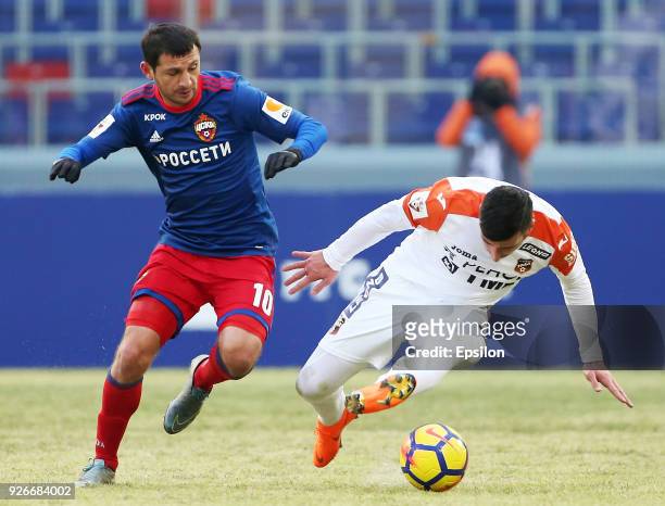 Alan Dzagoev of PFC CSKA Moscow vies for the ball with Georgy Chanturiya of FC Ural Ekaterinburg during the Russian Premier League match between PFC...