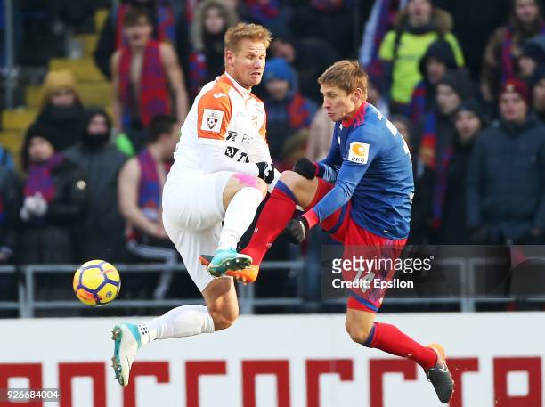 Kirill Nababkin of PFC CSKA Moscow vies for the ball with Grgor Balazhin of FC Ural Ekaterinburg during the Russian Premier League match between PFC...