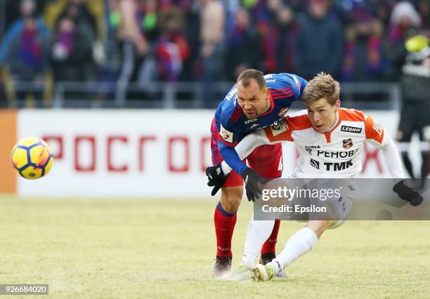 Sergei Ignashevich of PFC CSKA Moscow vies for the ball with Vladimir Ilyin of FC Ural Ekaterinburg during the Russian Premier League match between...